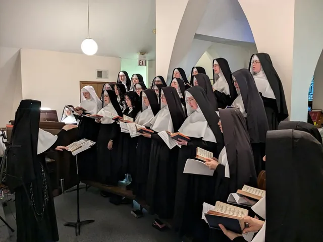 The Sisters singing together in choir.