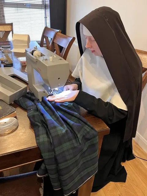 A Sister at work with the sewing machine.